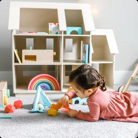 Toddler with wooden toys