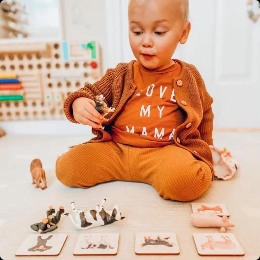 Toddler with Animal Match toy